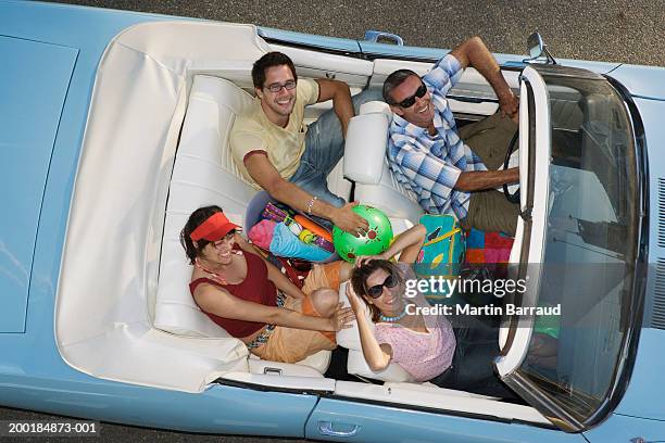 four people in convertible car, looking up, smiling, overhead view - sunglasses overhead fotografías e imágenes de stock