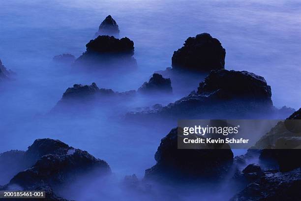 lava rocks and ocean shrouded in fog, dawn (long exposure) - île de l'ascension photos et images de collection