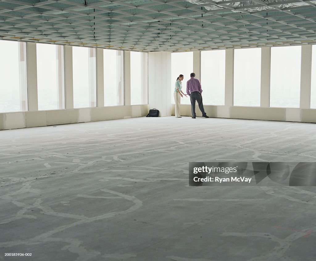 Business associates visiting empty office space
