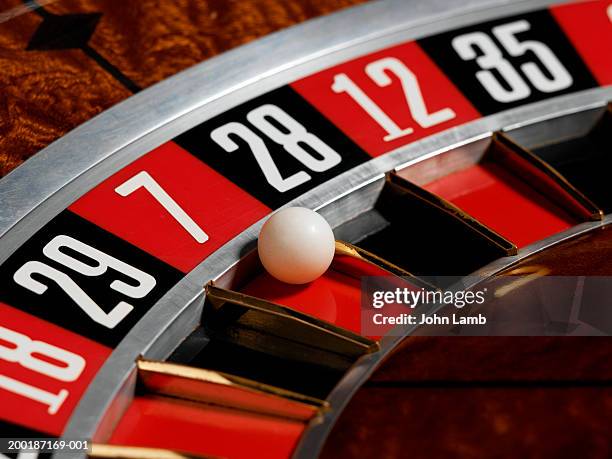 ball landing in red, number 7, on roulette wheel, close-up - roulette stock pictures, royalty-free photos & images