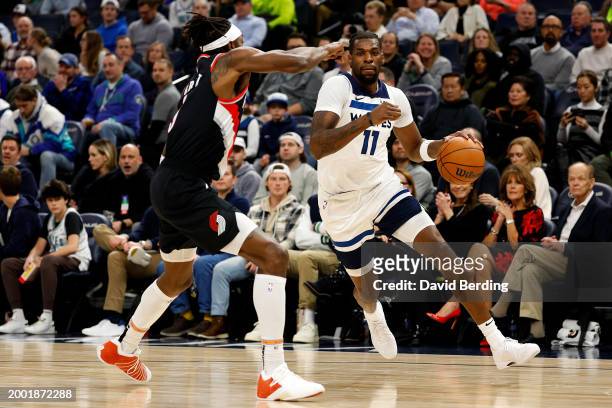 Naz Reid of the Minnesota Timberwolves drives to the basket against Jerami Grant of the Portland Trail Blazers in the second quarter at Target Center...