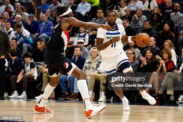 Naz Reid of the Minnesota Timberwolves drives to the basket against Jerami Grant of the Portland Trail Blazers in the second quarter at Target Center...