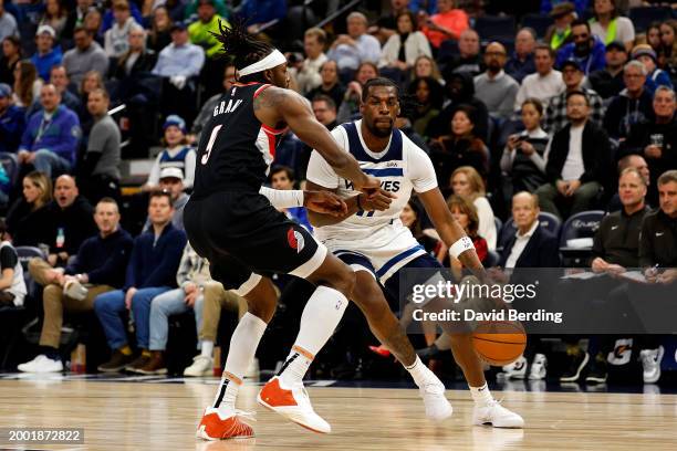 Naz Reid of the Minnesota Timberwolves drives to the basket against Jerami Grant of the Portland Trail Blazers in the second quarter at Target Center...