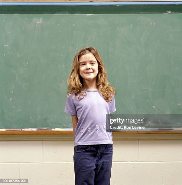 girl (9-11) in front of blackboard, portrait - shy girl stock pictures, royalty-free photos & images