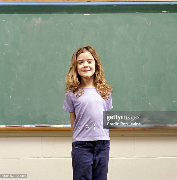 girl (9-11) in front of blackboard, portrait - children only laughing stock pictures, royalty-free photos & images