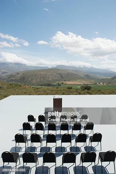 rows of empty chairs and empty lectern, outdoors, elevated view - stoneplus11 stock-fotos und bilder