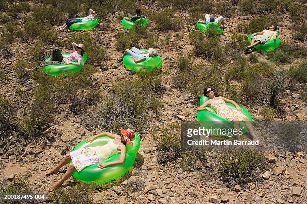 group of people on inflatable chairs, outdoors, elevated view - bubble chair stock-fotos und bilder