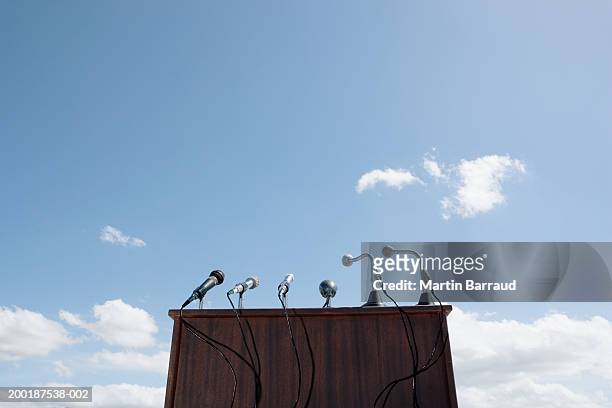 microphones on lectern, outdoors, low angle view - lectern stock pictures, royalty-free photos & images