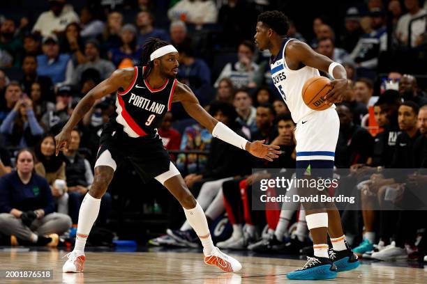 Anthony Edwards of the Minnesota Timberwolves dribbles the ball against Jerami Grant of the Portland Trail Blazers in the third quarter at Target...