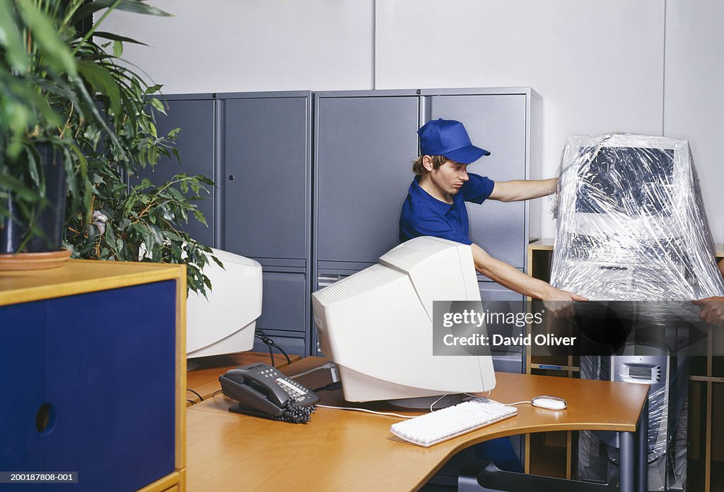 Wrapped Computer Two Men In Office Moving Plastic Wrapped Computer High-Res Stock Photo ...