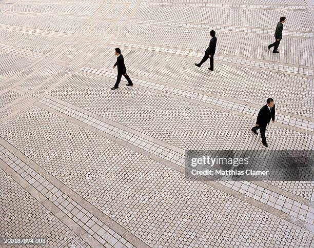 businessmen walking in plaza, elevated view - opposite direction stock pictures, royalty-free photos & images