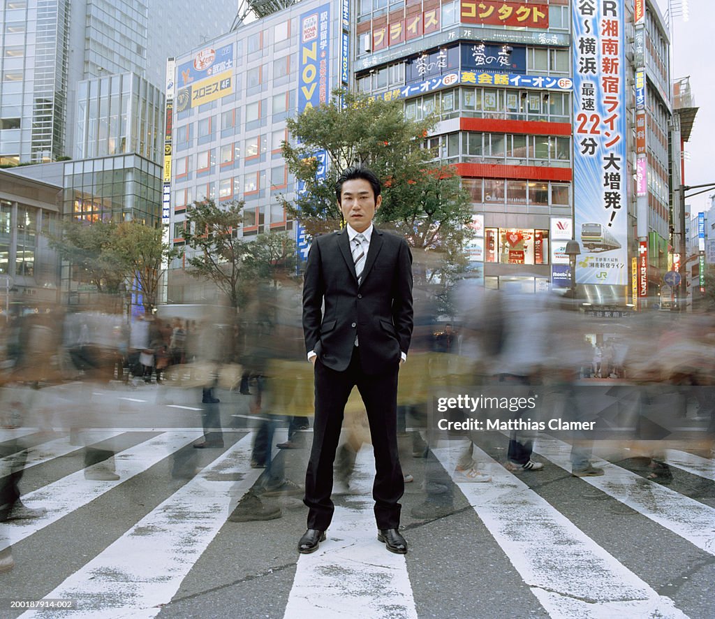 Businessmen standing in crosswalk (long exposure)