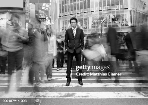 Businessmen standing in crosswalk (long exposure, B&W)) Businessmen standing in crosswalk (long exposure, B&W))
