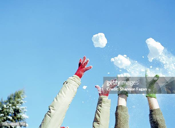 two people throwing snowballs in air - bola de neve imagens e fotografias de stock
