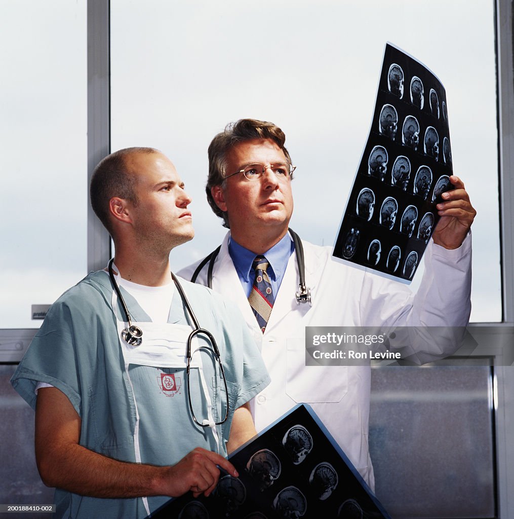 Two male doctors looking at brain MRI x-rays