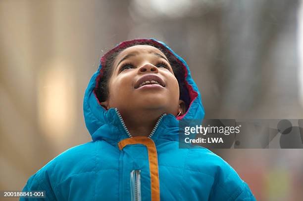 girl (6-9) wearing coat looking up - awe stock pictures, royalty-free photos & images