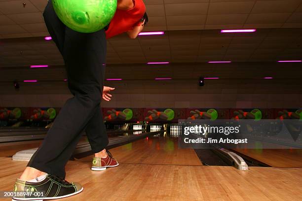 young man preparing to bowl, rear view - bowling shoe stock pictures, royalty-free photos & images