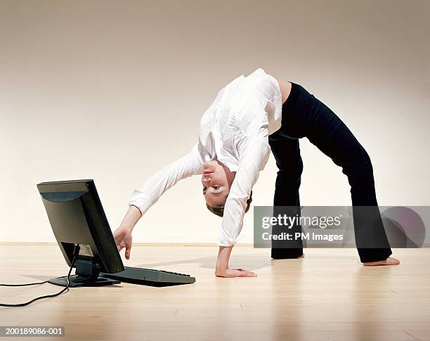 Businesswoman Bent Over Backwards Using Laptop High-Res Stock Photo ...