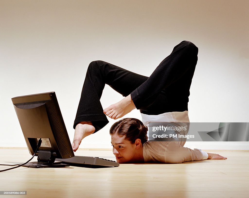 Businesswoman using laptop with toes