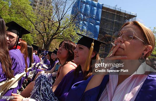 Making a statement against Mayor Michael Bloomberg's new anti-smoking laws, a New York University graduating student smokes while the mayor speaks...