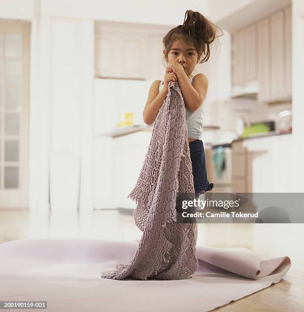 girl (3-6) with finger in mouth holding knitted blanket, portrait - thumb sucking stock pictures, royalty-free photos & images