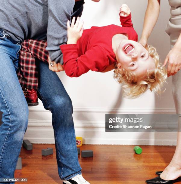 woman holding girl (2-4) having tantrum, low section - trotzanfall stock-fotos und bilder