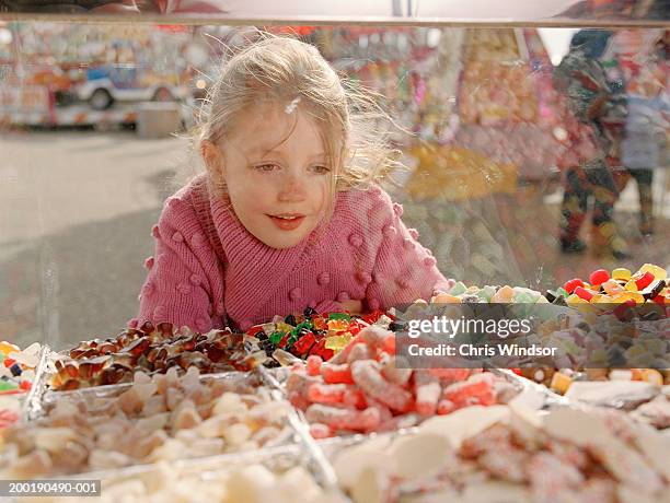 girl (7-9) looking at sweets in glass counter - kid candy store stock pictures, royalty-free photos & images