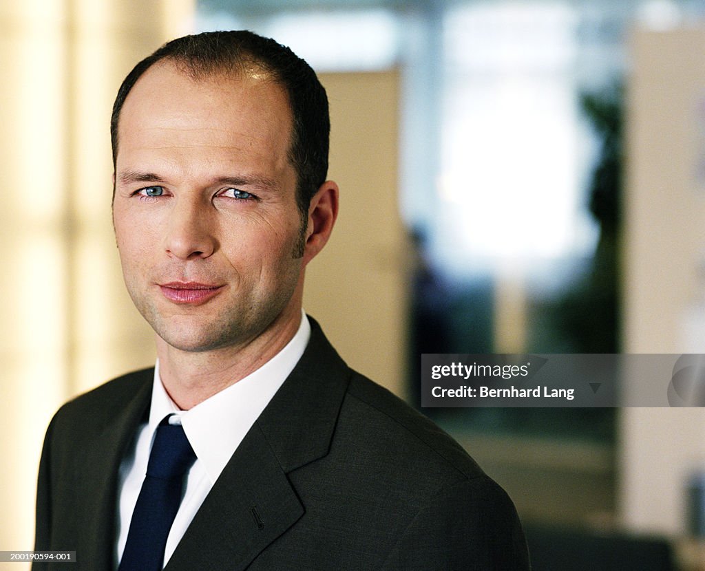 Businessman smiling, portrait, close-up