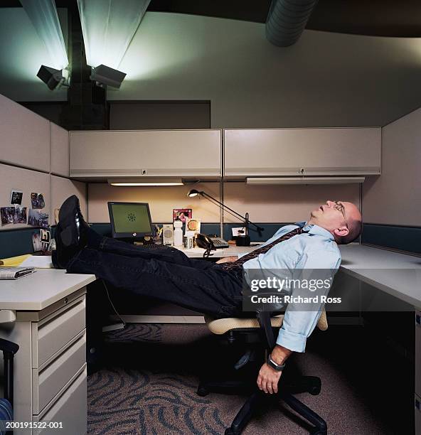 businessman sleeping in work cubicle - feet on table bildbanksfoton och bilder