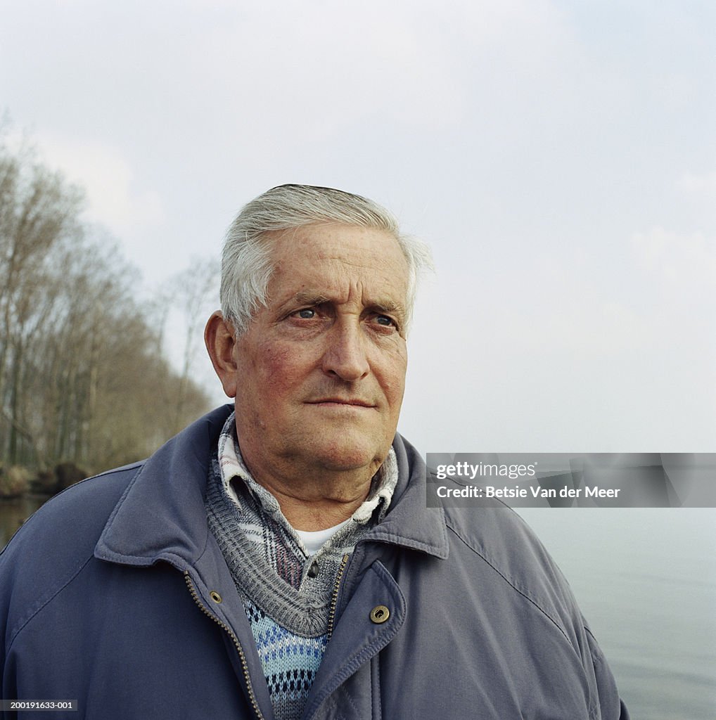 Senior man by lake, close-up