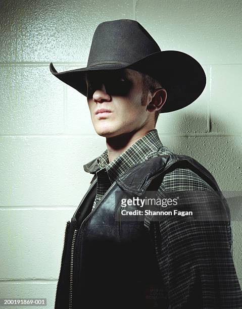 young man in cowboy hat and leather vest, portrait - cow boy photos et images de collection