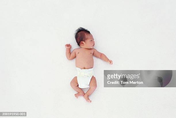 newborn baby boy (0-3 months) lying on back, overhead view - baby on white stock-fotos und bilder
