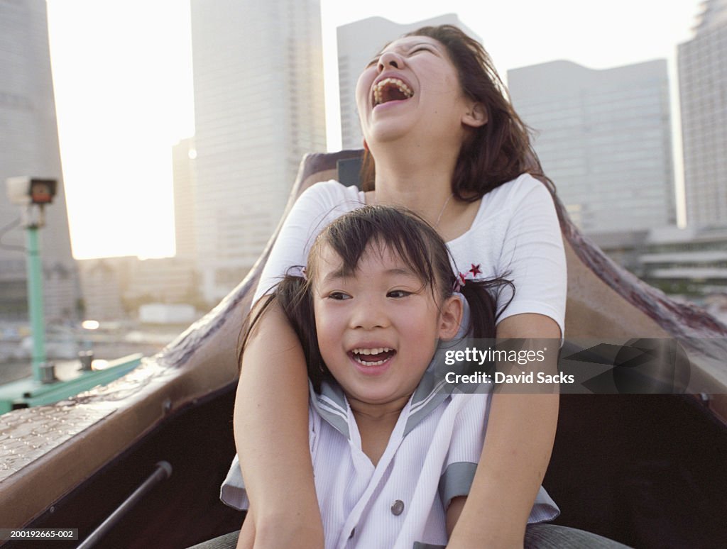 Mother and daughter (3-5) riding in boat