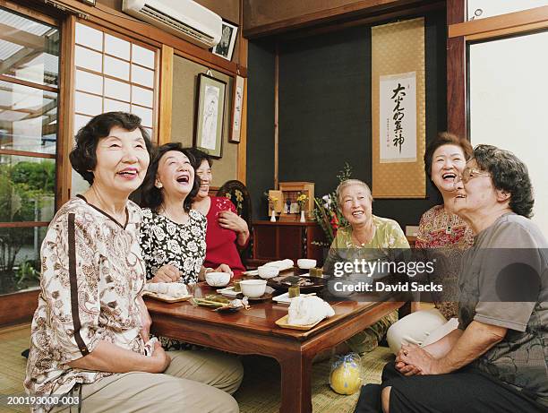 six senior women having tea, laughing - japanese old woman stock pictures, royalty-free photos & images