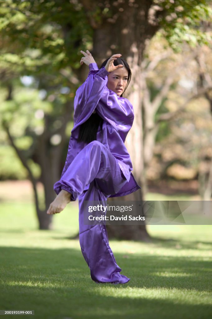 Woman practicing martial arts in park