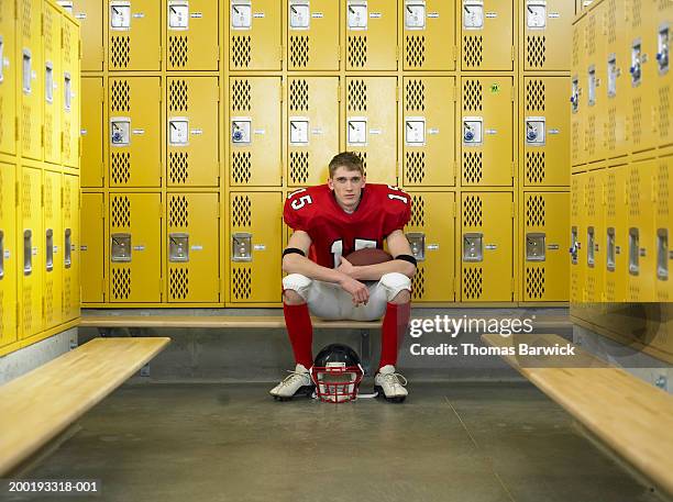 teenage football player (15-17), sitting in locker room, portrait - student athlete stock pictures, royalty-free photos & images