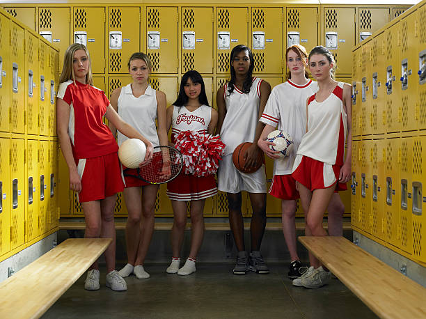 group of teenage girls (15-17) standing in locker room, portrait - girls volleyball stock pictures, royalty-free photos & images
