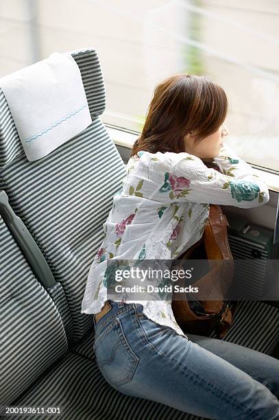 woman looking out of train window, side view - travel16 stock pictures, royalty-free photos & images