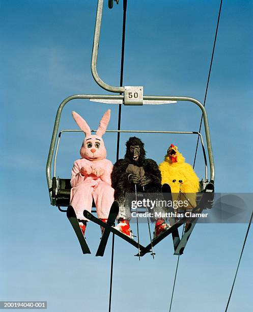 people wearing animal costumes riding ski lift - creepy foto e immagini stock