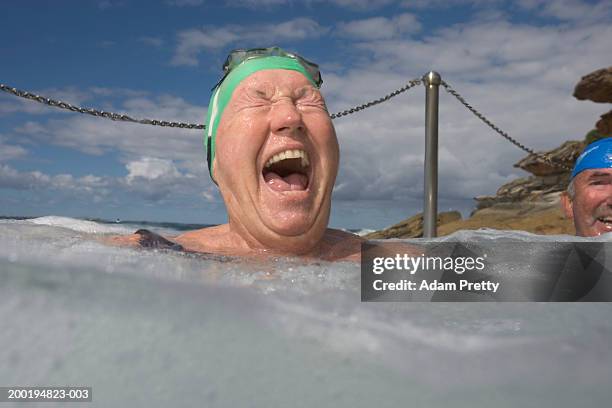 senior woman in infinity pool, laughing, close-up - euphoric female stock pictures, royalty-free photos & images