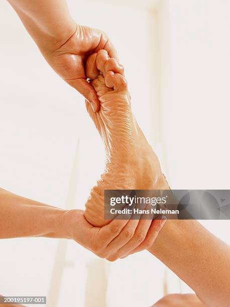 woman massaging man's foot, close-up - woman foot massage stock pictures, royalty-free photos & images