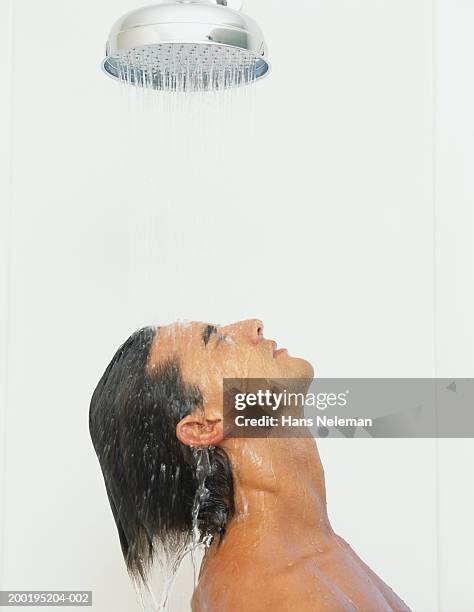 young man taking shower - shower head stock pictures, royalty-free photos & images