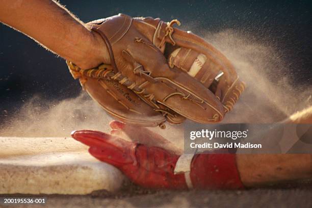 baseball player sliding into base, baseman tagging player, close-up - baseball sport fotografías e imágenes de stock