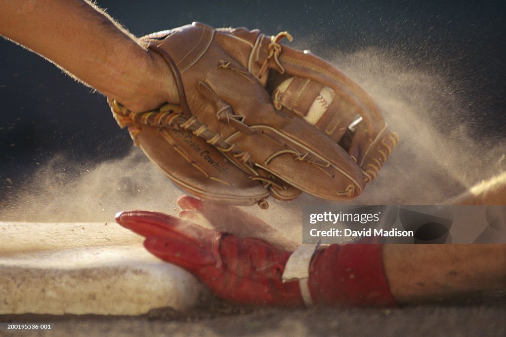 Baseball player sliding into base, baseman tagging player, close-up