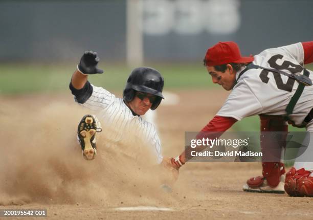 baseball player sliding into home plate, being tagged by catcher - baseball player sliding stock pictures, royalty-free photos & images