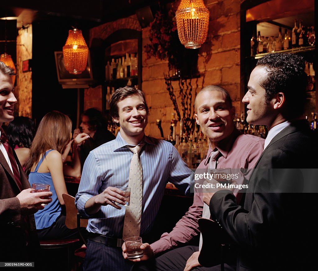 Businessmen talking at bar