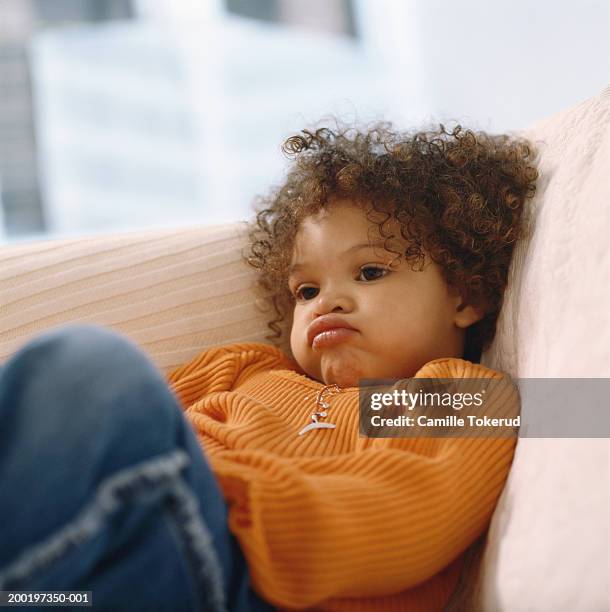 girl (2-4) on sofa, close-up - pouting stock pictures, royalty-free photos & images