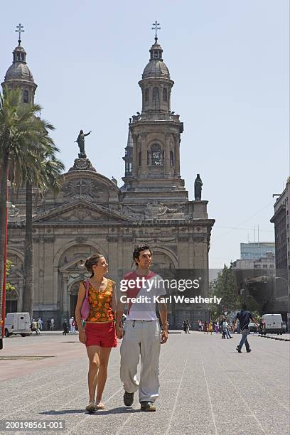 chile, santiago, young couple walking through square, holding hands - santiago chile stock pictures, royalty-free photos & images