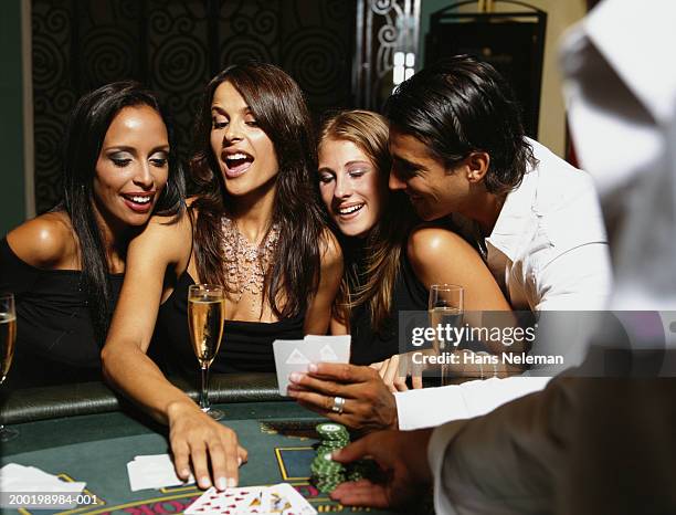 young people playing cards at casino - casino dealer stockfoto's en -beelden