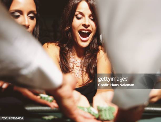 two women at gaming table collection chips - casinò foto e immagini stock